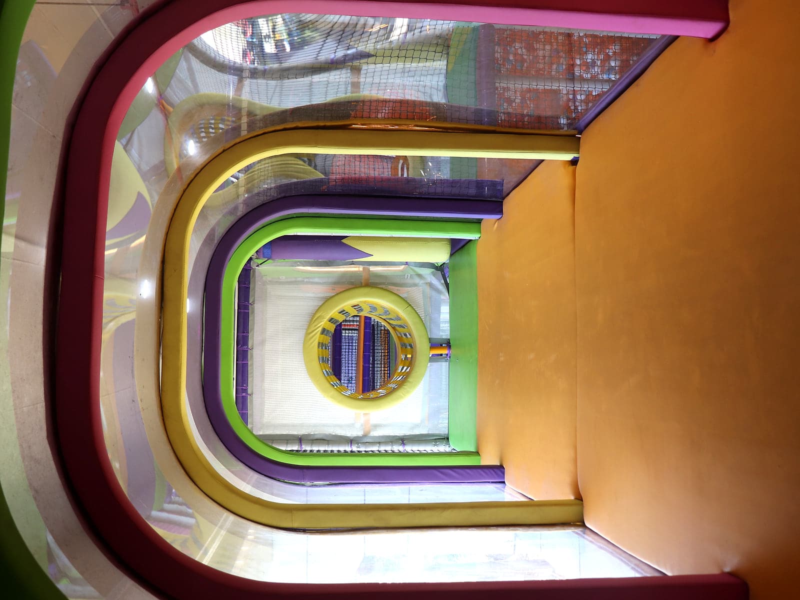 Rainbow arch tunnel inside the multi-level soft play adventure structure